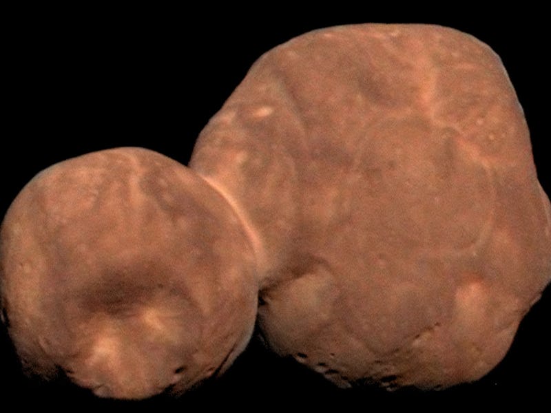 Close-up image of a distant celestial body resembling two connected spheres with a textured, uneven ...