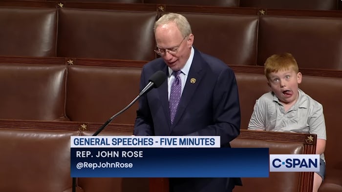 Rep. Rose delivers a speech on the floor of Congress while his son, Guy, makes silly faces behind h...