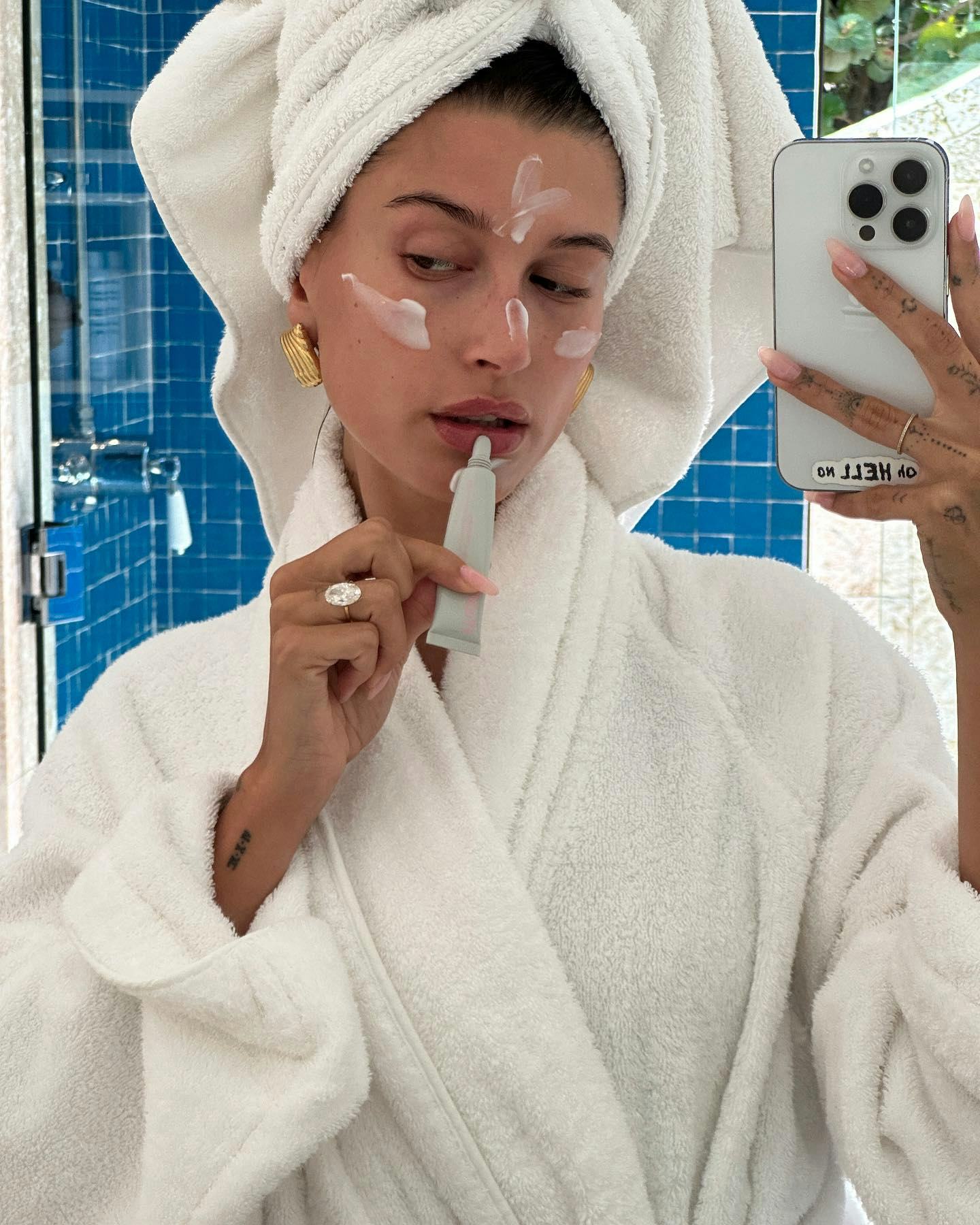 Hailey Bieber shares a bathroom selfie with her massive engagement ring on full display.