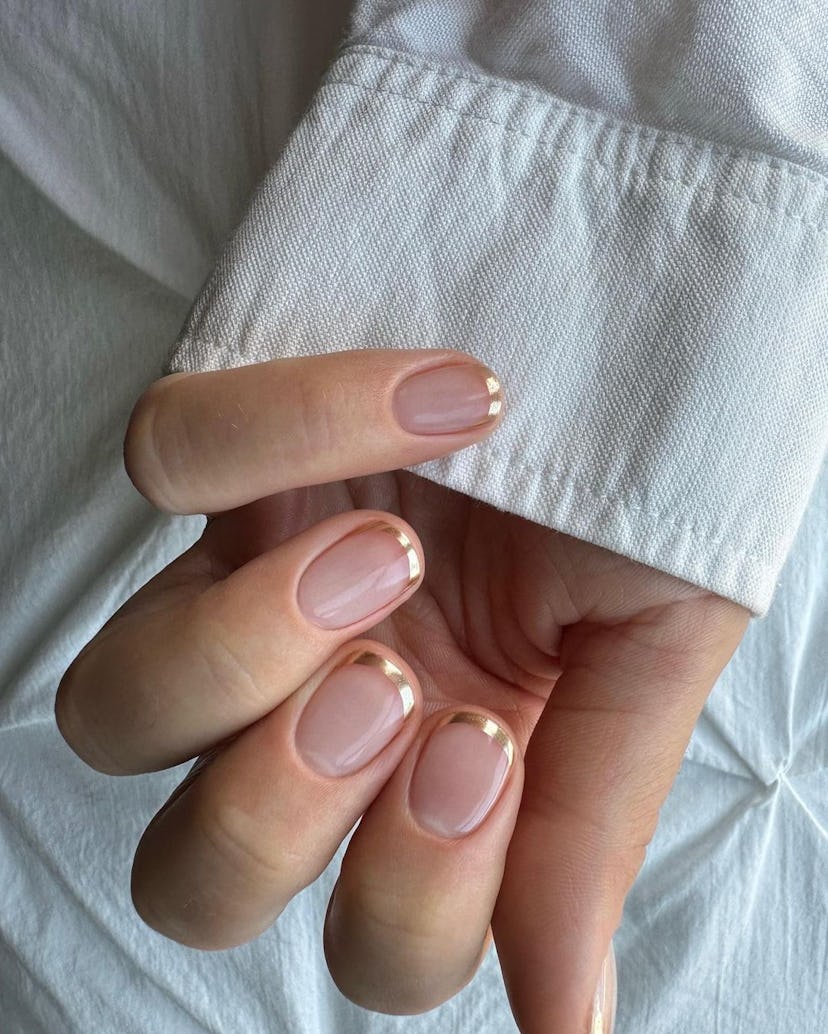 Golden French tip nails are perfect for a Leo on their wedding day.