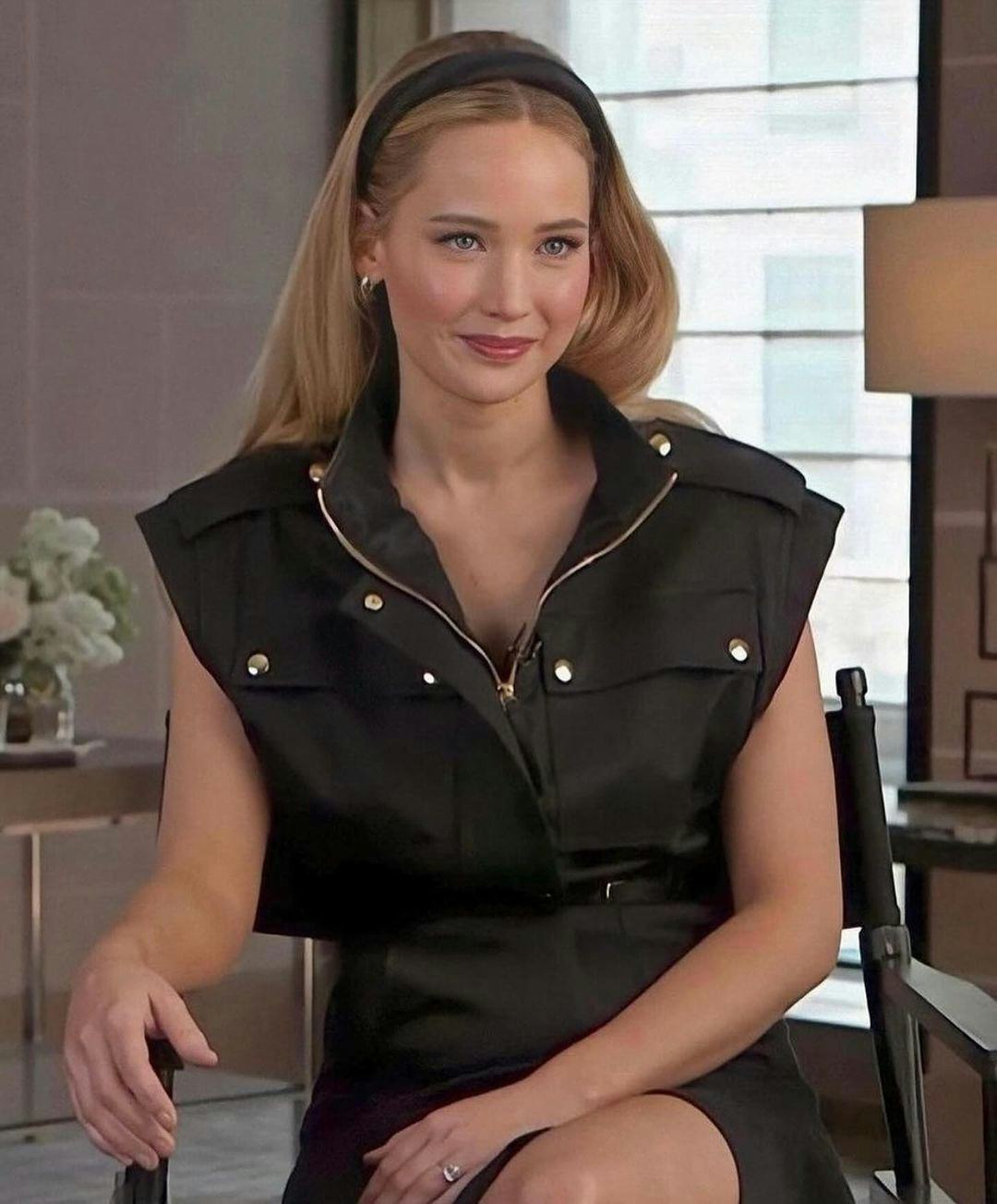 Jennifer Lawrence wears a utilitarian black dress and headband.