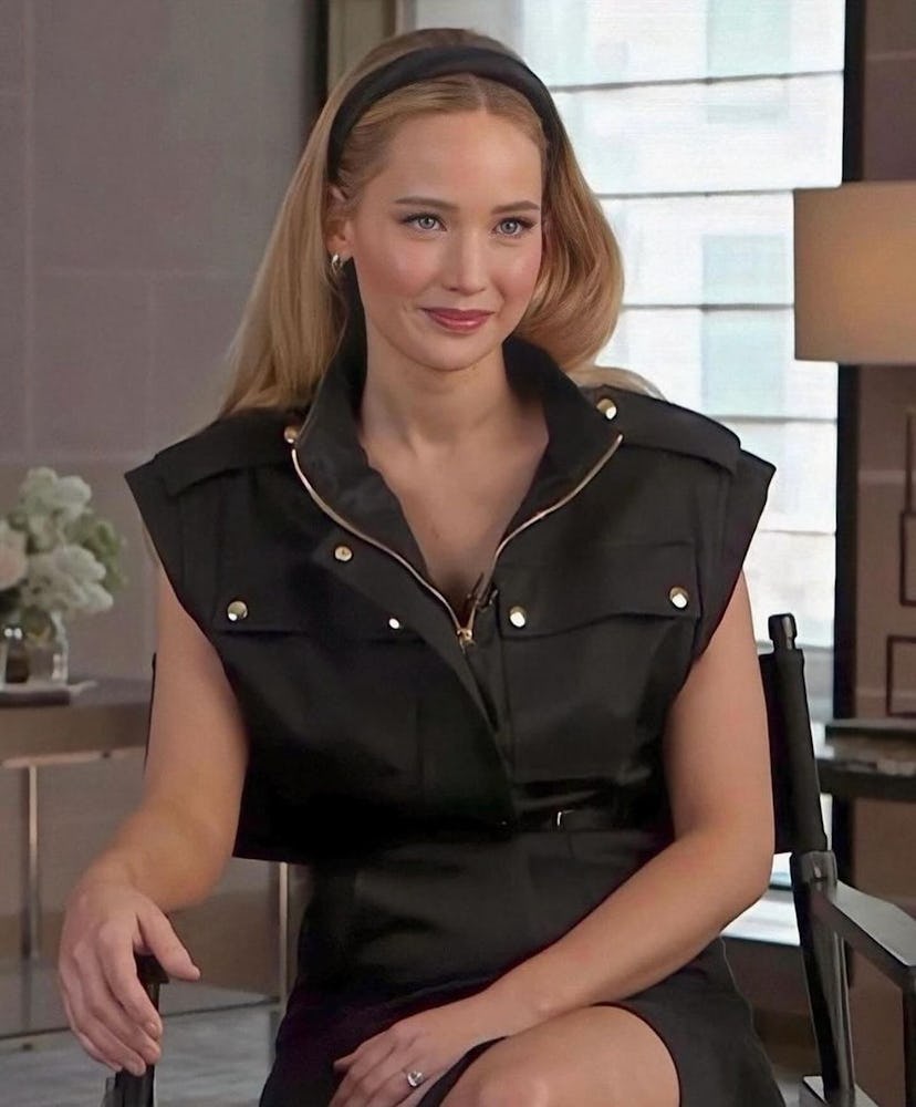 Jennifer Lawrence wears a utilitarian black dress and headband.