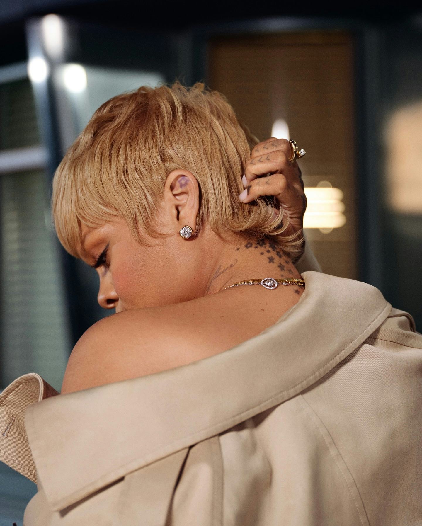 Rihanna wore an oversized trench coat and diamonds to announce her new line of Fenty Hair products.