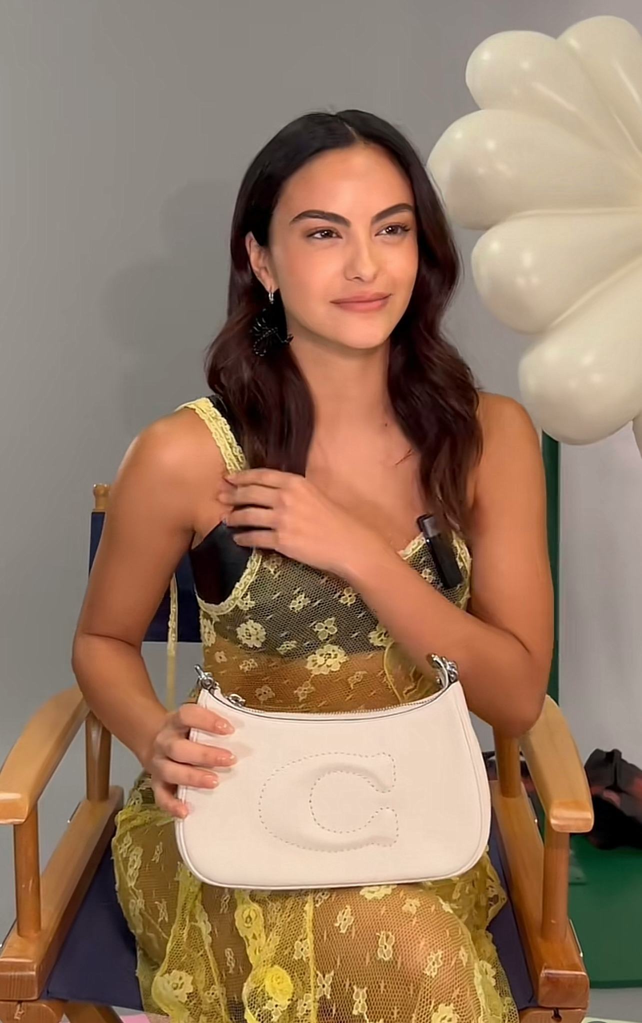 Camila Mendes carries the Coach Teri bag in a TikTok video.