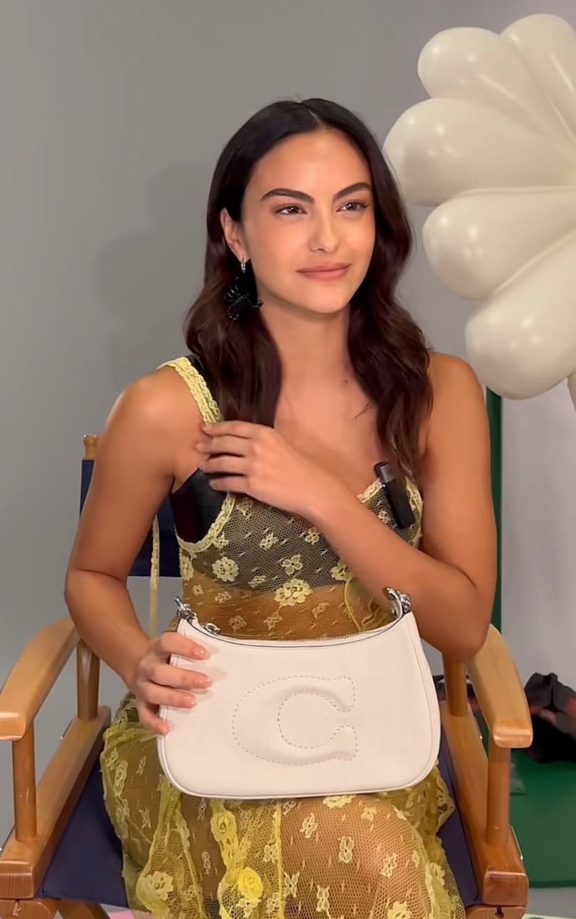 Camila Mendes carries the Coach Teri bag in a TikTok video.  