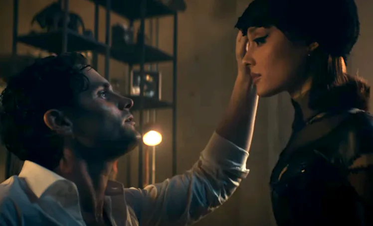 Ariana Grande channels Penn Badgley's 'You' character in her "The Boy Is Mine" music video.