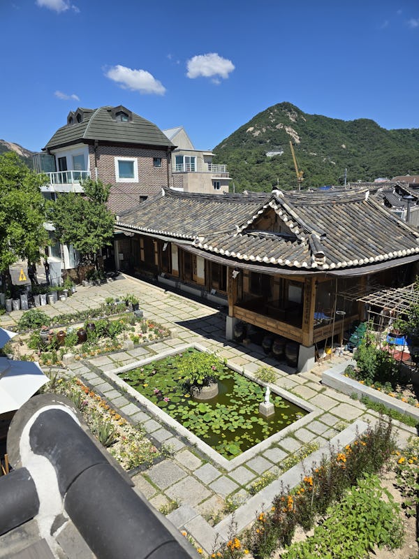 From the top of the Bukchon Observatory, guests can see panoramic views of the Hanok Village below i…