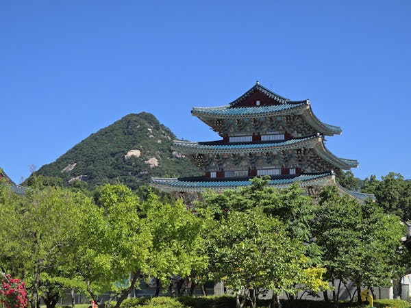 Gyeongbokgung Palace in Seoul, South Korea, in front of South Korean mountains