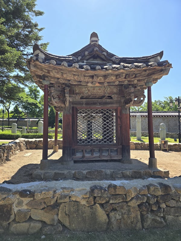 Traditional Korean gazebo with ornate wooden roof and lattice design.