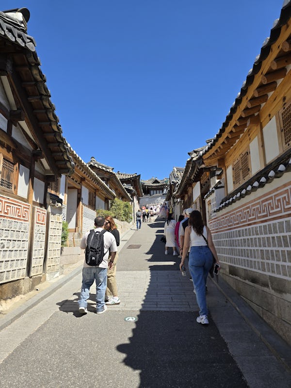 Tourists walk up the many hills in Seoul's traditional Korean Bukchon Hanok Village