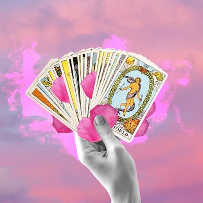 A hand holding a fan of Tarot cards against a pink and purple cloud background, prominently featuring the "World" card.