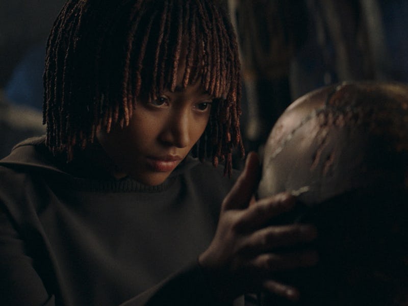 Osha (Amandla Stenberg) stares at a Sith helmet in The Acolyte