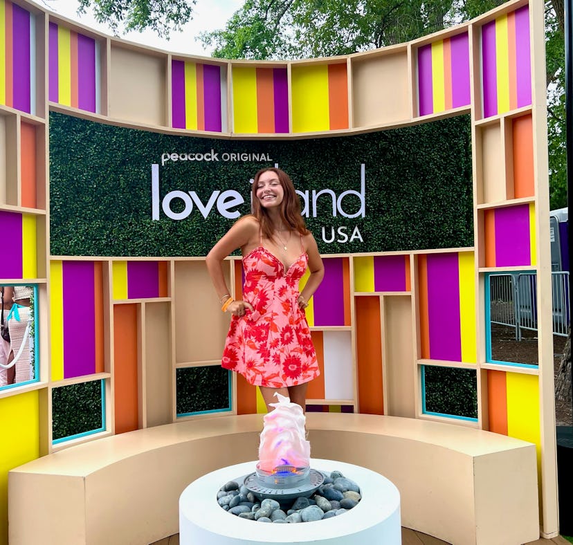 Girl in front of 'Love Island USA' sign, auditioning for the show.