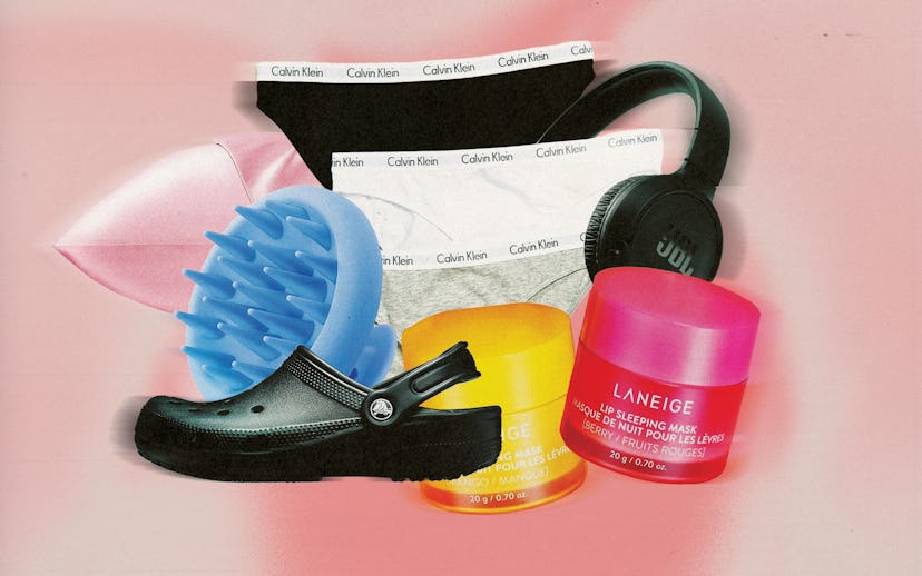 Assorted items including a black shoe, blue brush, underwear, and colorful cosmetics on a pink backg...