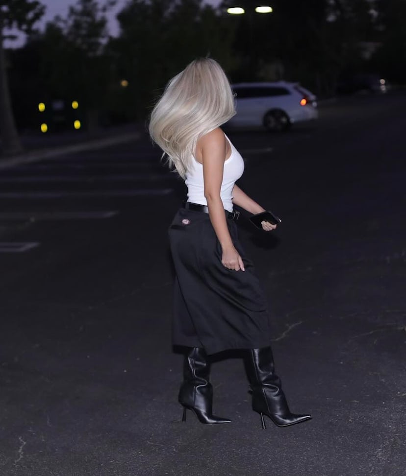 Kim Kardashian wore a tailored Bermuda shorts and white tank top outfit in impromptu parking lot pho…