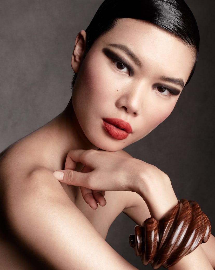 A model wears a dark eye and red lip