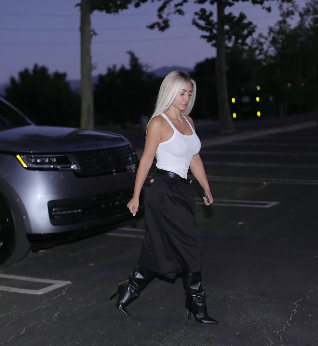 Kim Kardashian wore a tailored Bermuda shorts and white tank top outfit in impromptu parking lot pho&hellip;
