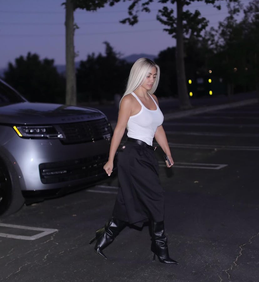 Kim Kardashian wore a tailored Bermuda shorts and white tank top outfit in impromptu parking lot pho…