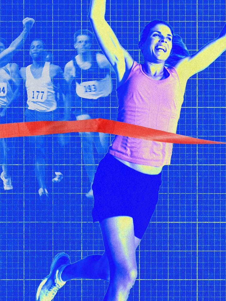 A female runner triumphantly crosses the finish line, celebrating her victory. Ghosted images of oth...