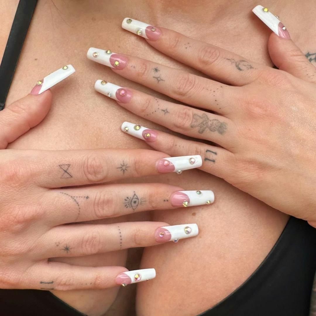 Megan Fox showed off her healed hand tattoos and studded French tip nails in July 2024.