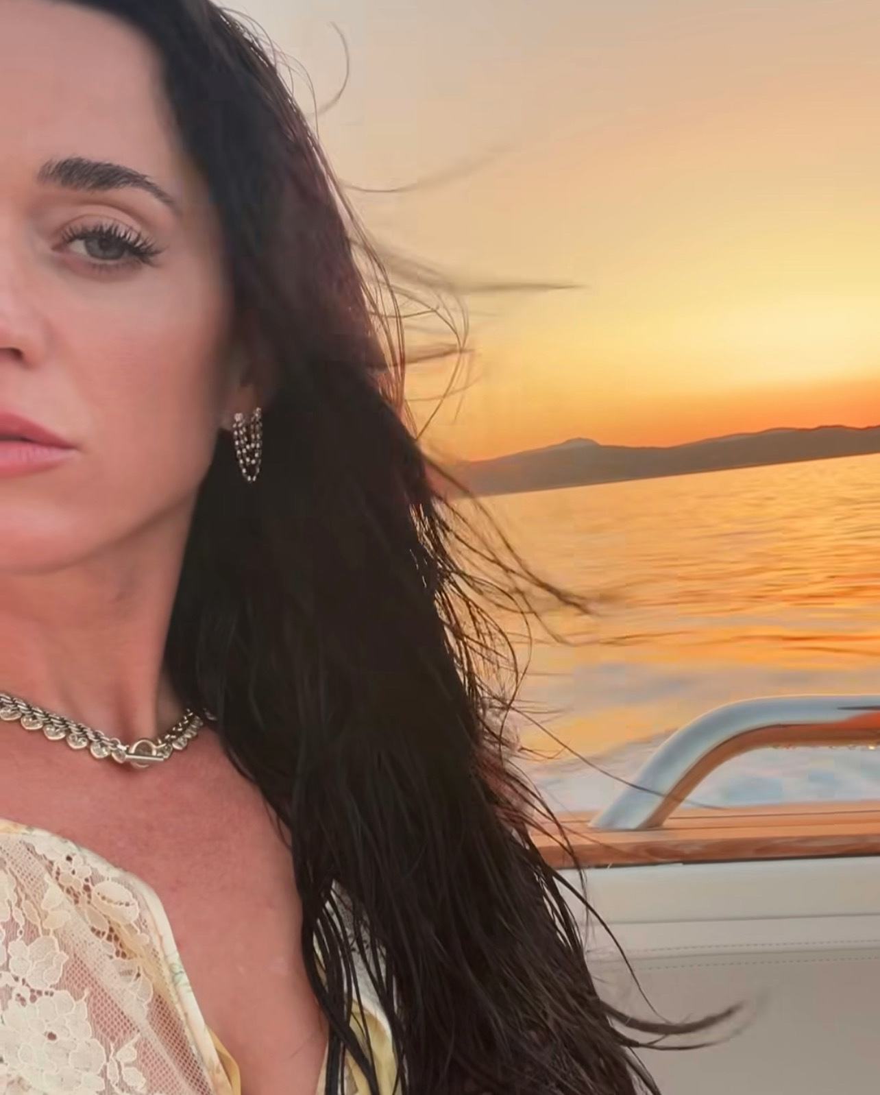 Katy Perry wears gold accessories and a lace outfit.