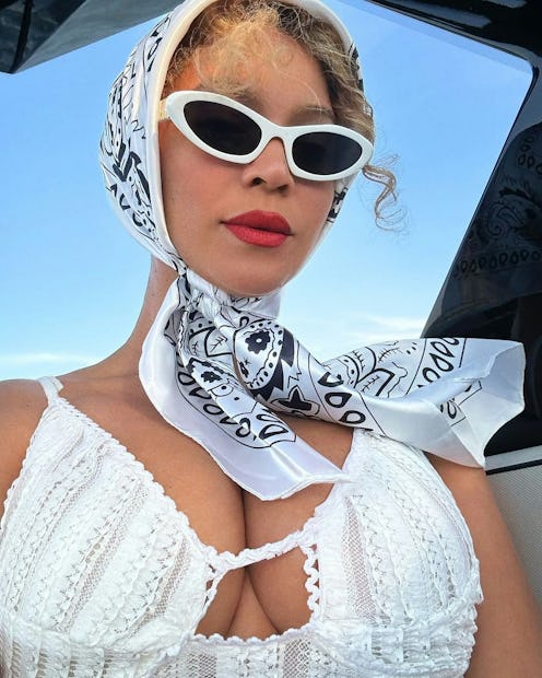 Beyonce wears a white dress and head scarf in posh cowboycore.