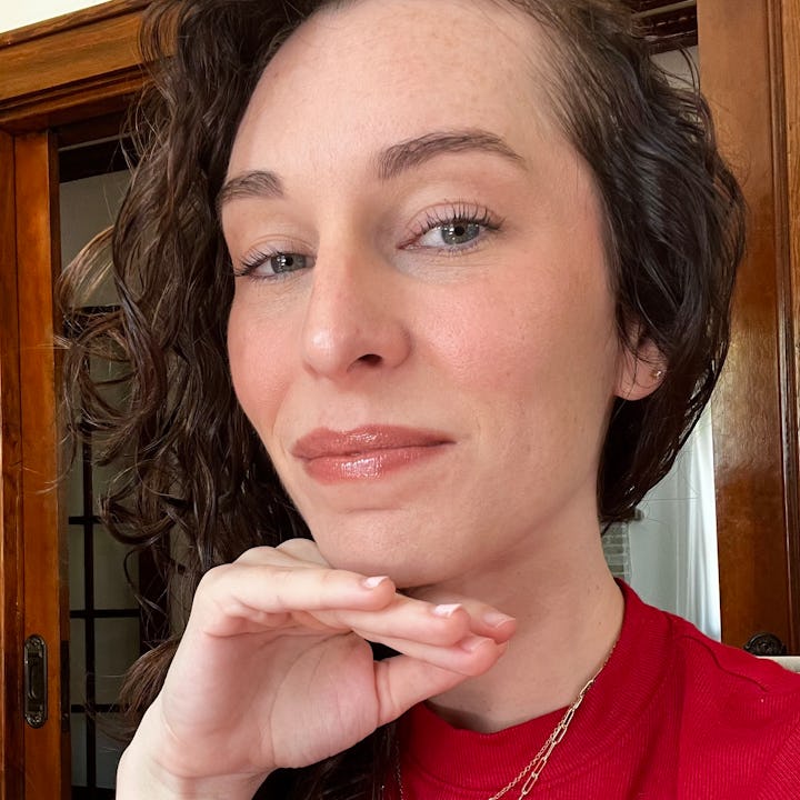 The author smiling to camera to show her 5-minute makeup routine that looks good on Zoom.