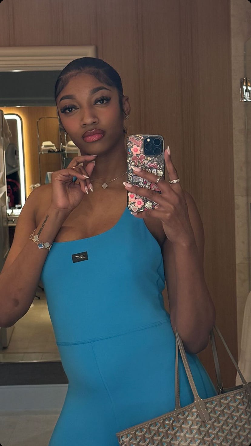 Angel Reese posed for a selfie before the game carrying a Goyard designer tote bag.