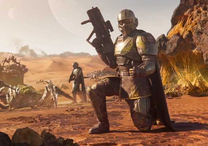 A futuristic soldier in armor kneels on a desert planet, holding a large gun, with more figures and wreckage in the background.