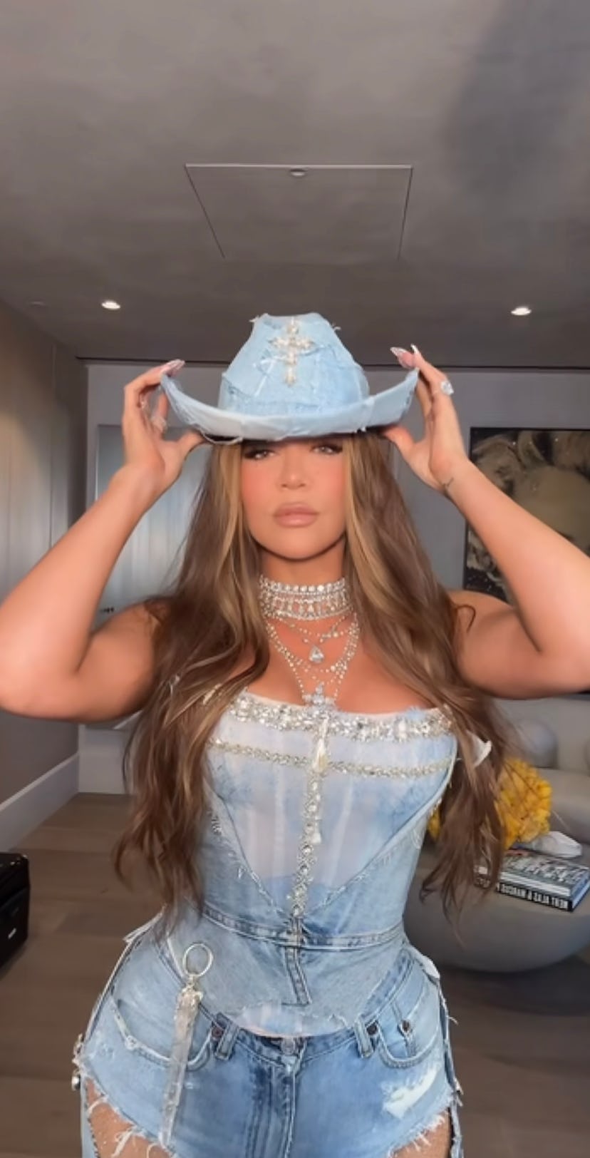 Khloé Kardashian wears a bedazzled denim corset and assless chaps on her 40th birthday. 