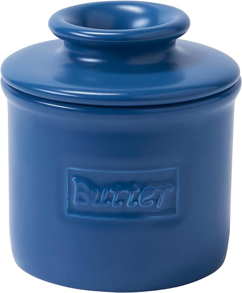 A cobalt blue ceramic butter dish with a matching lid, featuring embossed "Butter" text on the side.