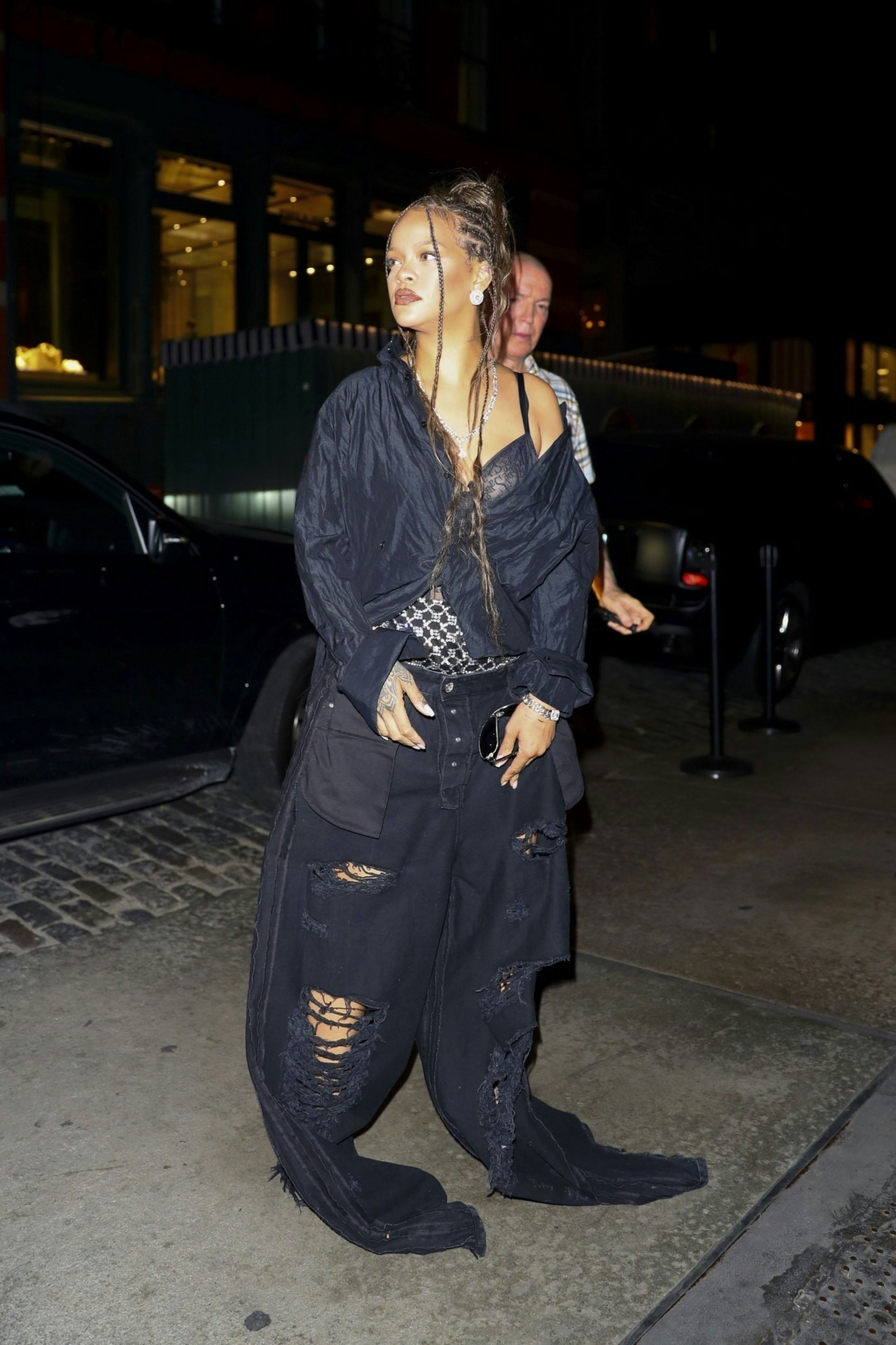 Rihanna wears an all-black look.