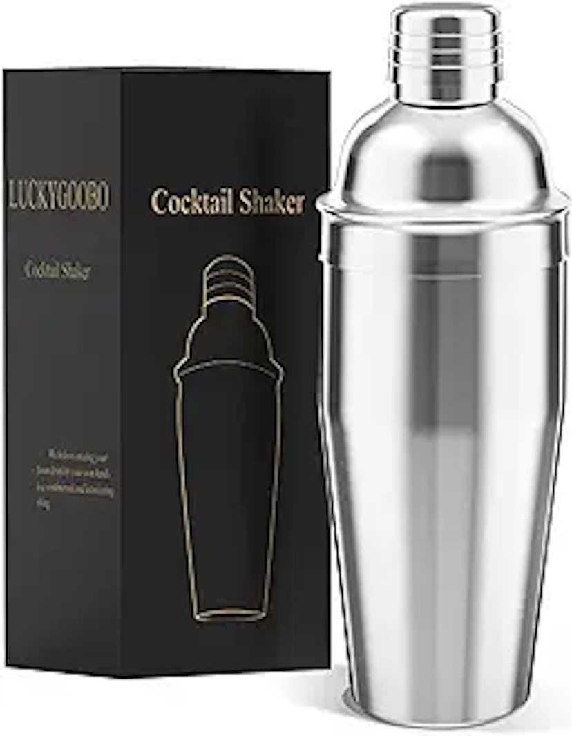 Stainless steel cocktail shaker next to its black packaging box with a graphic of the shaker.