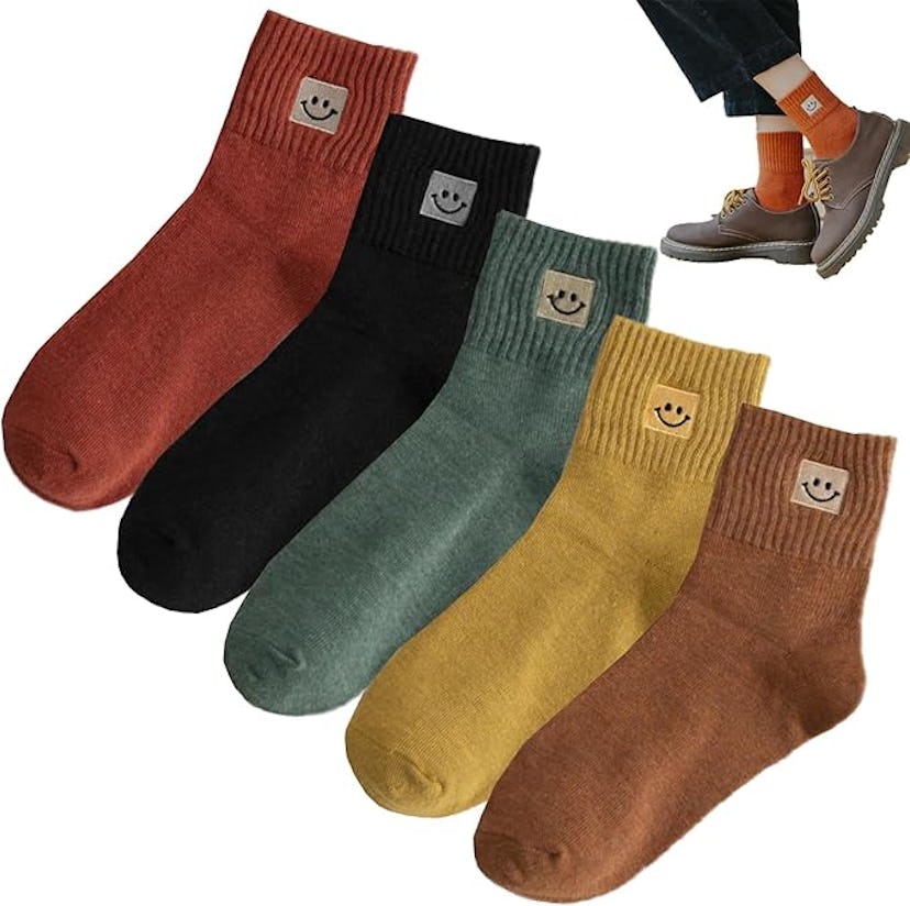 Six pairs of colorful socks in red, black, green, yellow, and brown, each adorned with a cute smiley...