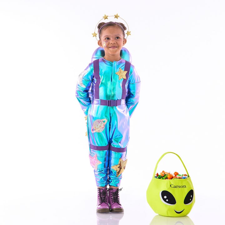 Little girl dressed in blue and purple astronaut costume with a crown of stars from Pottery Barn Kid...
