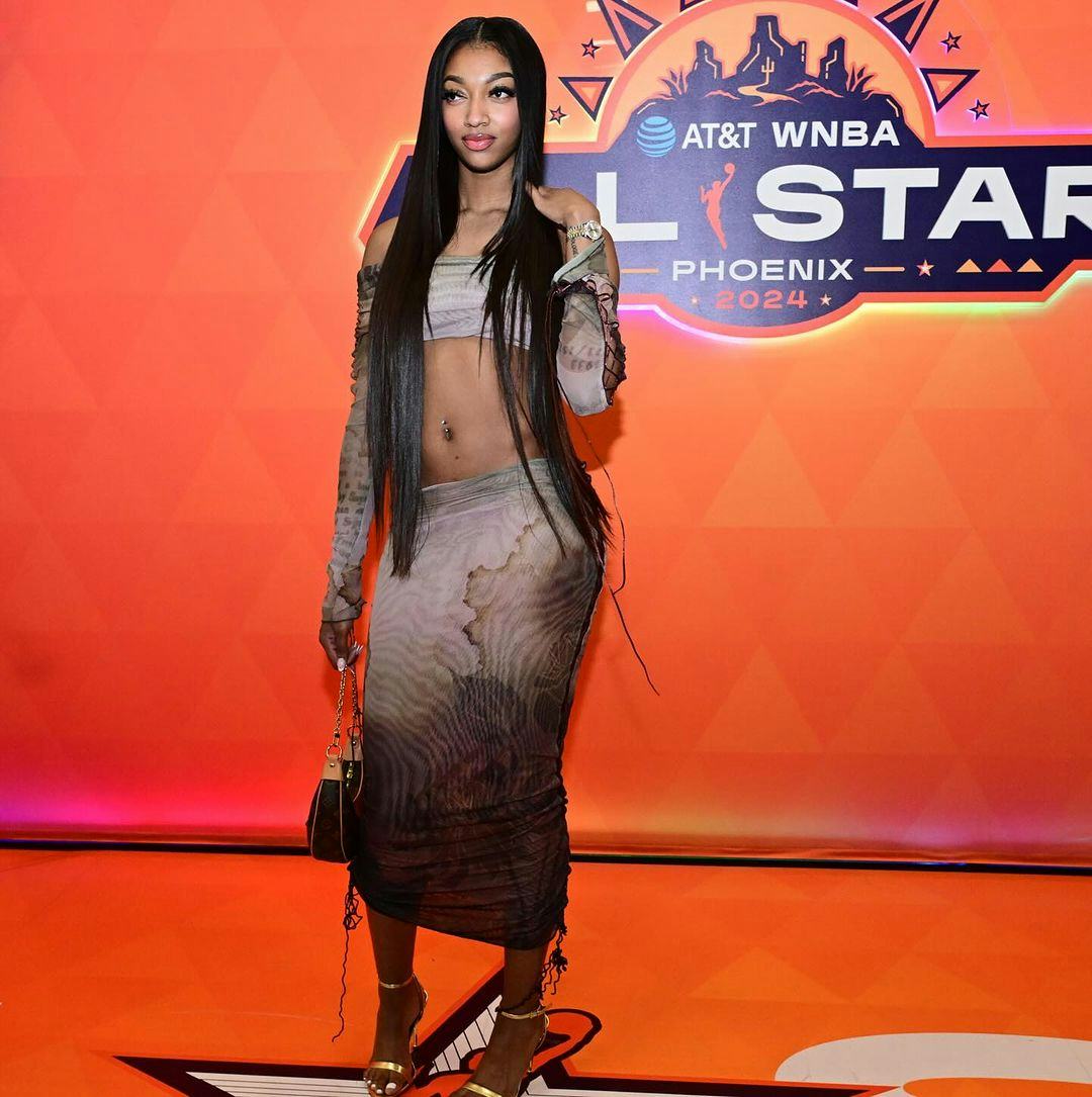 Angel Reese wears a crop top and skirt.