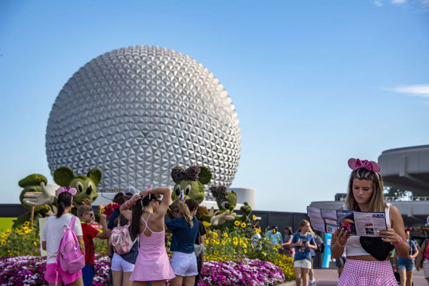 Guests at Disney World wear outfits with matching Mouse Ears.
