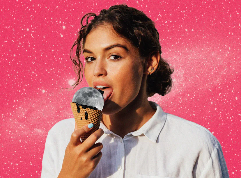 Young woman licking a moon ice cream before reading her August 2024 horoscope.