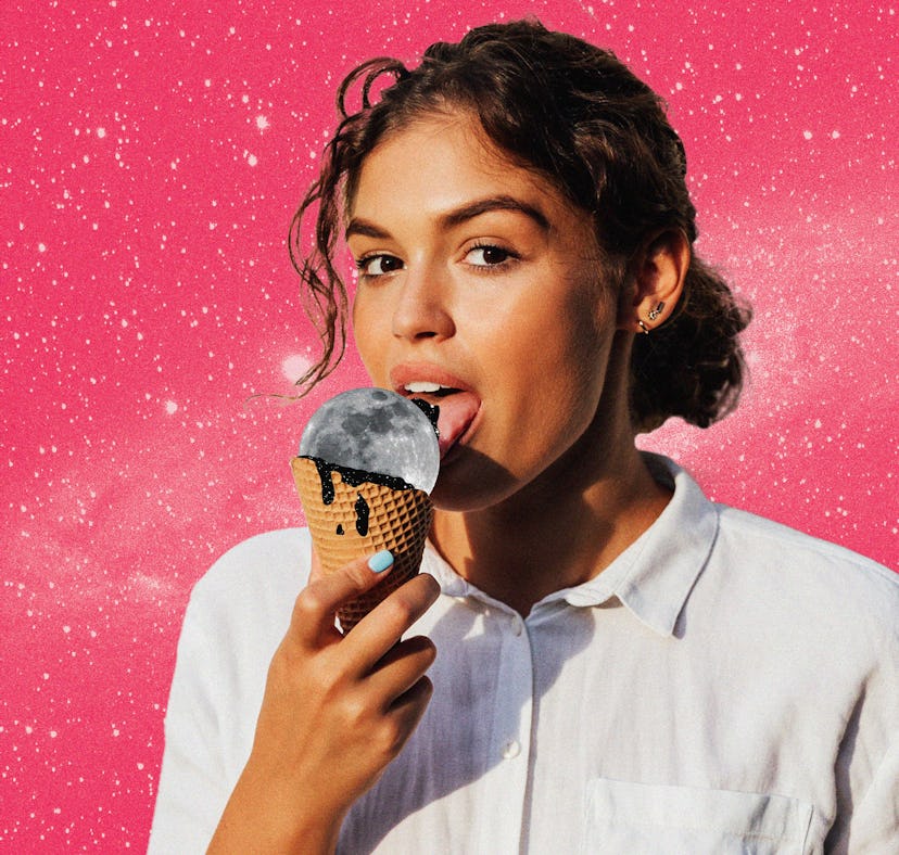 Young woman licking a moon ice cream before reading her August 2024 horoscope.