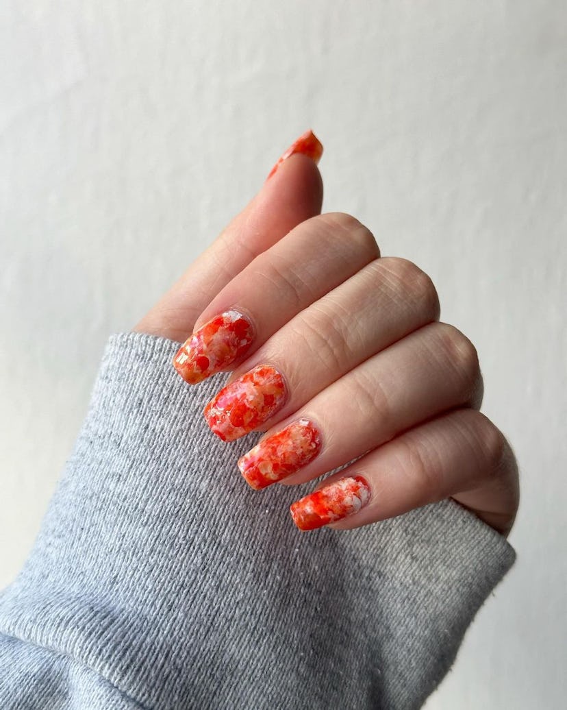 Try “aperol spritz nails” with orange tie dye art.