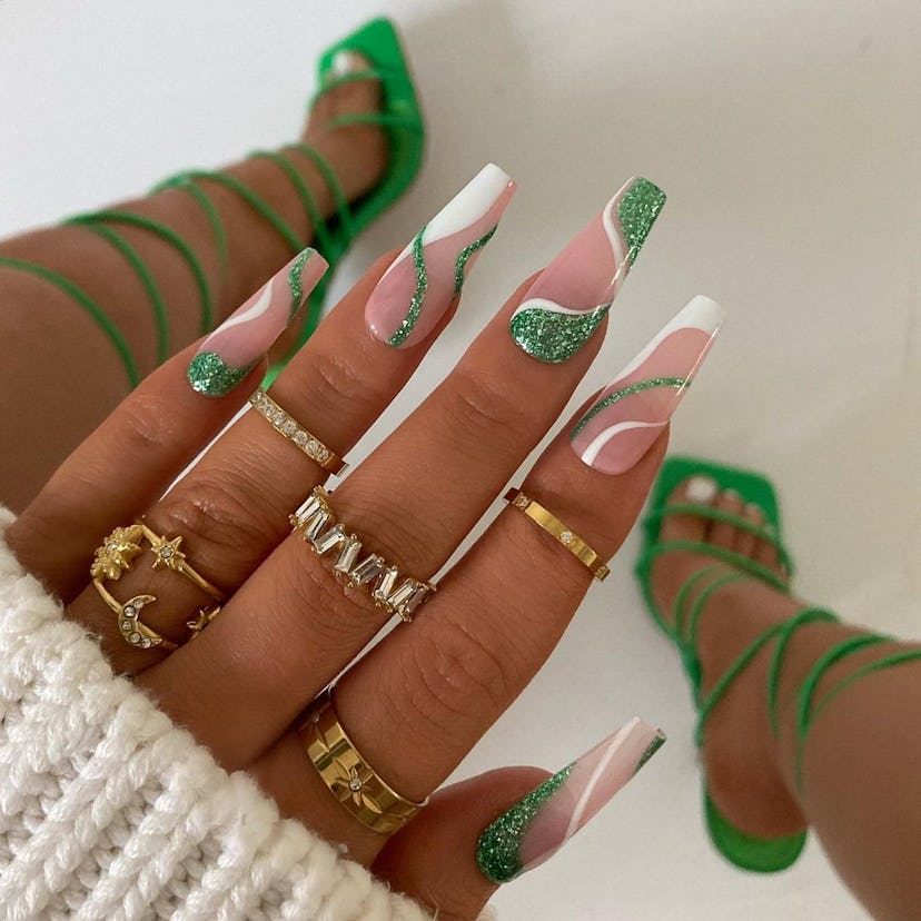 Sparkling green swirl nail art gives “brat summer” vibes.