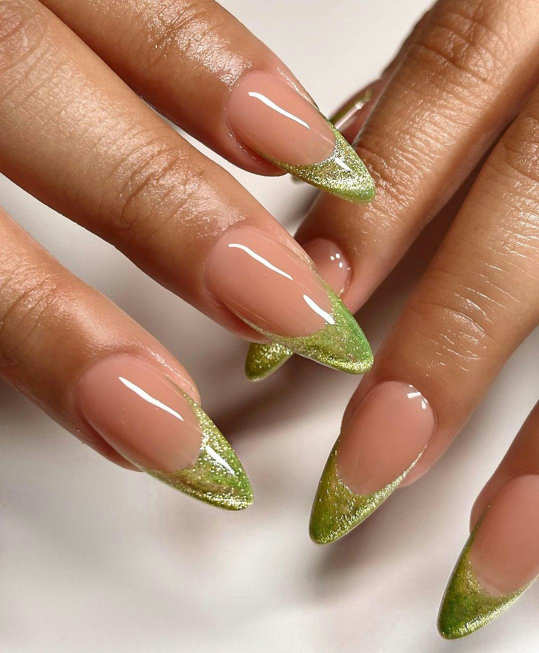 Glittering lime green French tips nails give &ldquo;brat summer&rdquo; vibes.