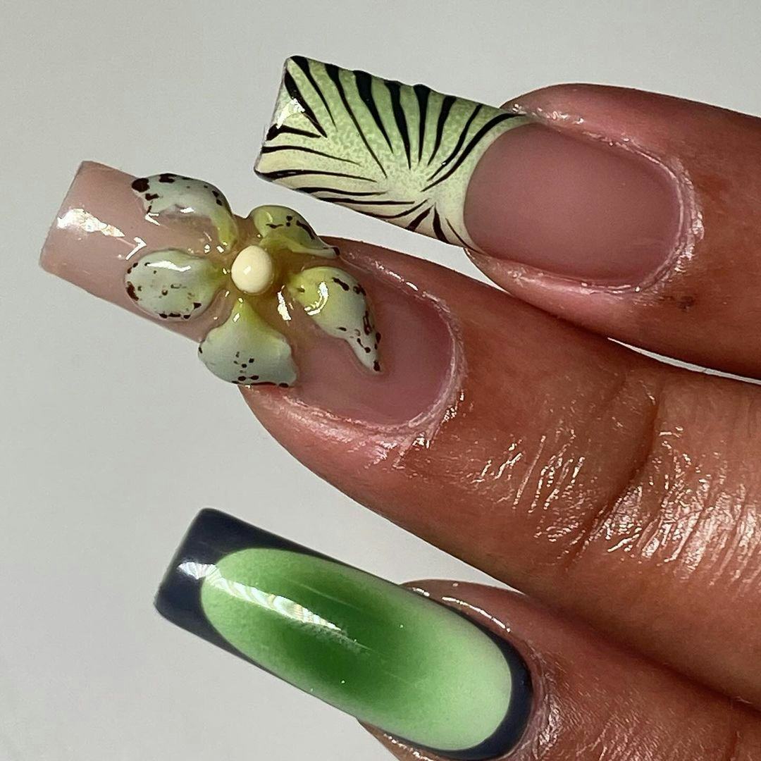 Green tropical orchid nail art gives &ldquo;brat summer&rdquo; vibes.