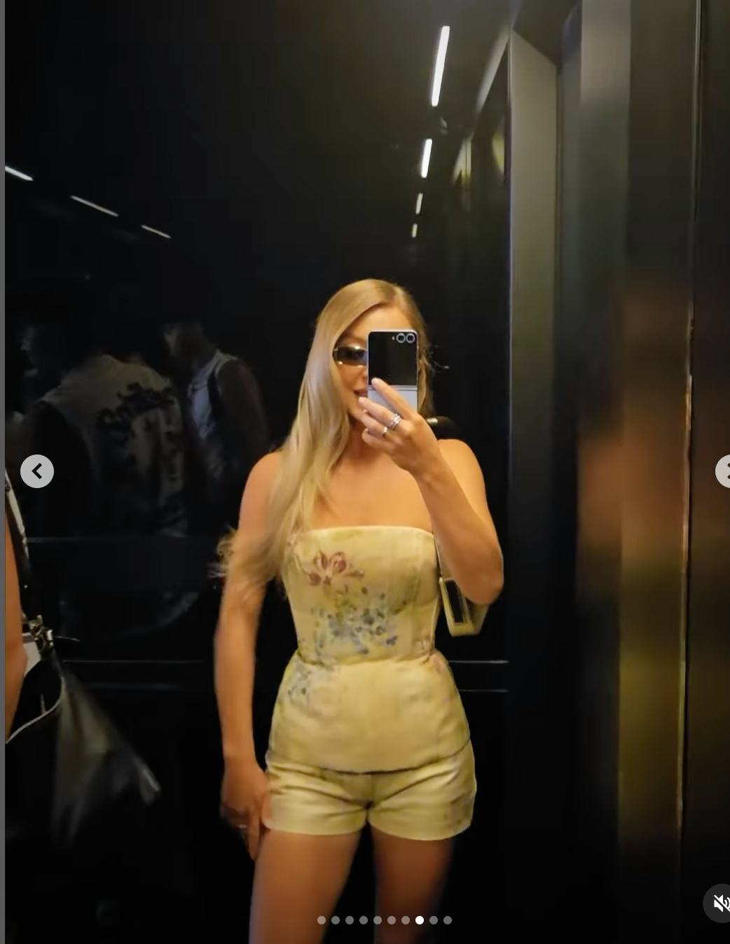 Sydney Sweeney taking a mirror selfie wearing a floral bustier.
