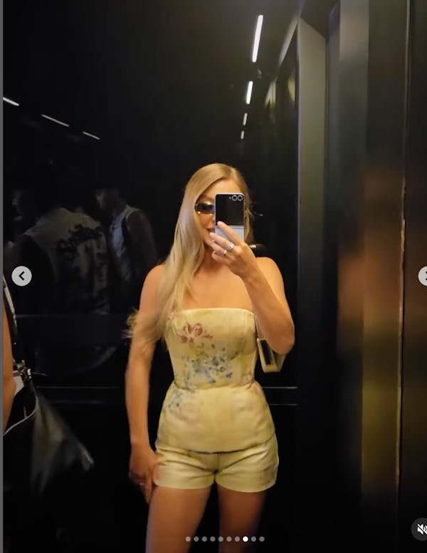 Sydney Sweeney taking a mirror selfie wearing a floral bustier.