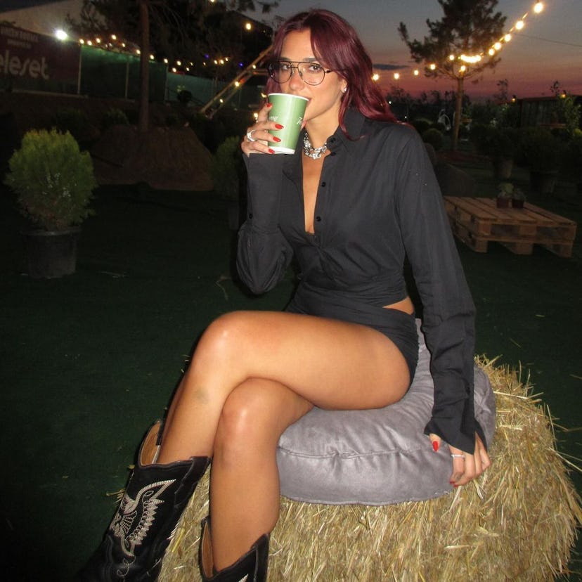 Dua Lipa posing for a photo wearing cowboy boots at Sunny Hill Festival in Kosovo.