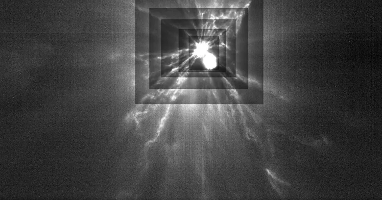 A plume fans out from a central bright region like wings. The central bright region is surrounded by...