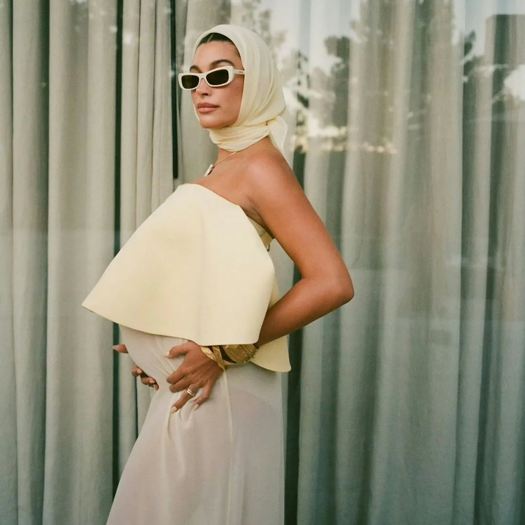 Hailey Bieber Flaunts Her Baby Bump In a Sheer Butter Yellow Dress Hailey Bieber Flaunts Her Baby Bump In a Sheer Butter Yellow Dress