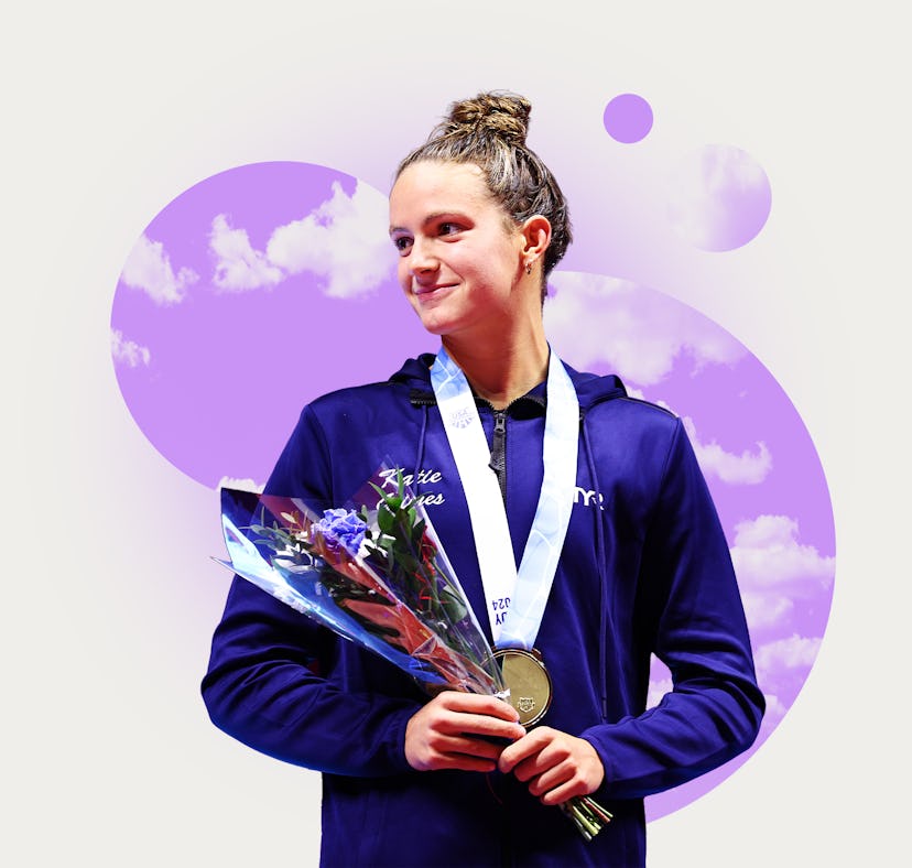 Female athlete in a blue jacket holding a medal and flowers, smiling against a purple abstract backg...
