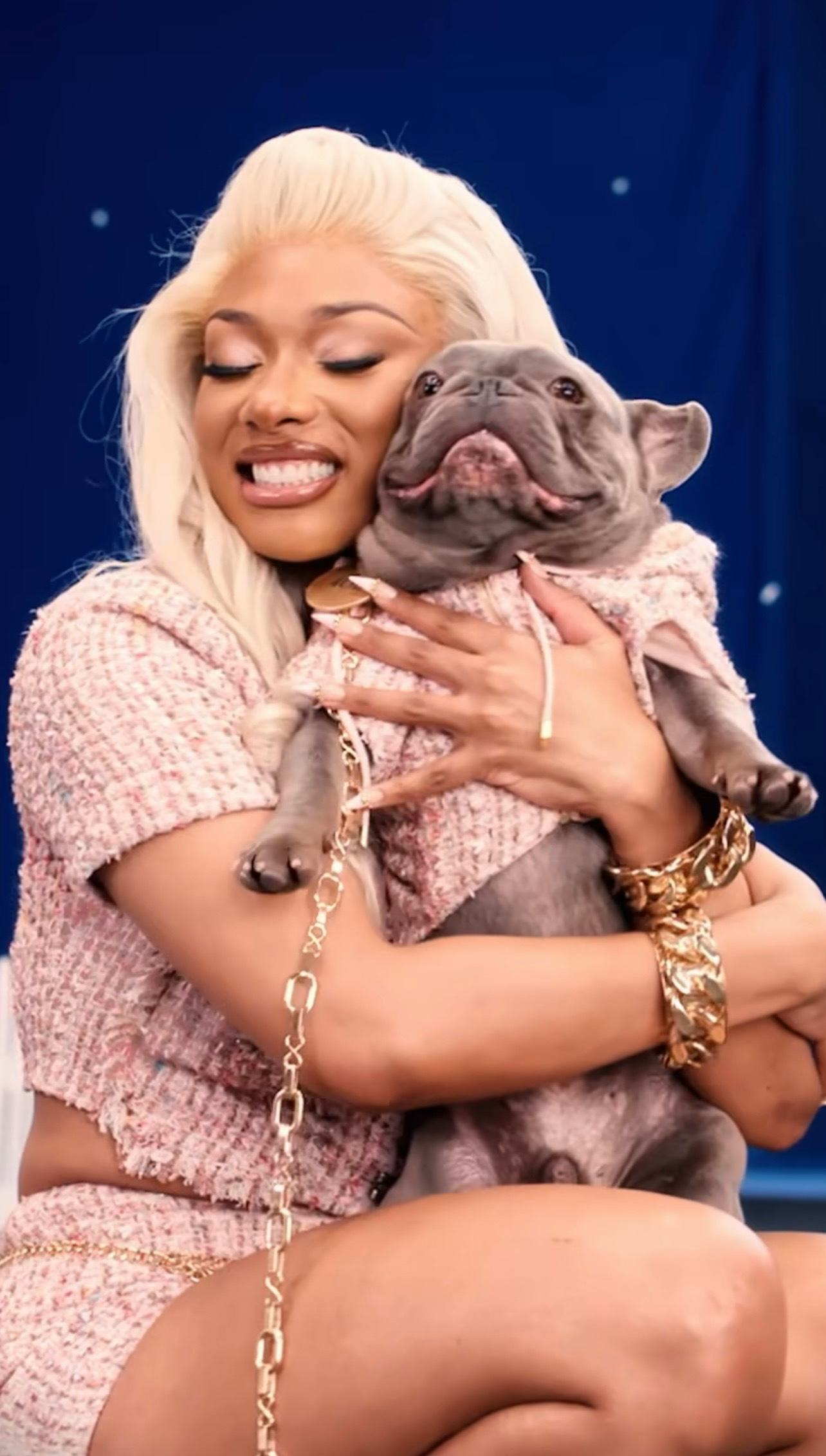 Megan Thee Stallion wears a pink tweed shorts set with her Frenchie, 4oe.